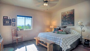 Une chambre à coucher avec un lit, une fenêtre, un bureau et une chaise.