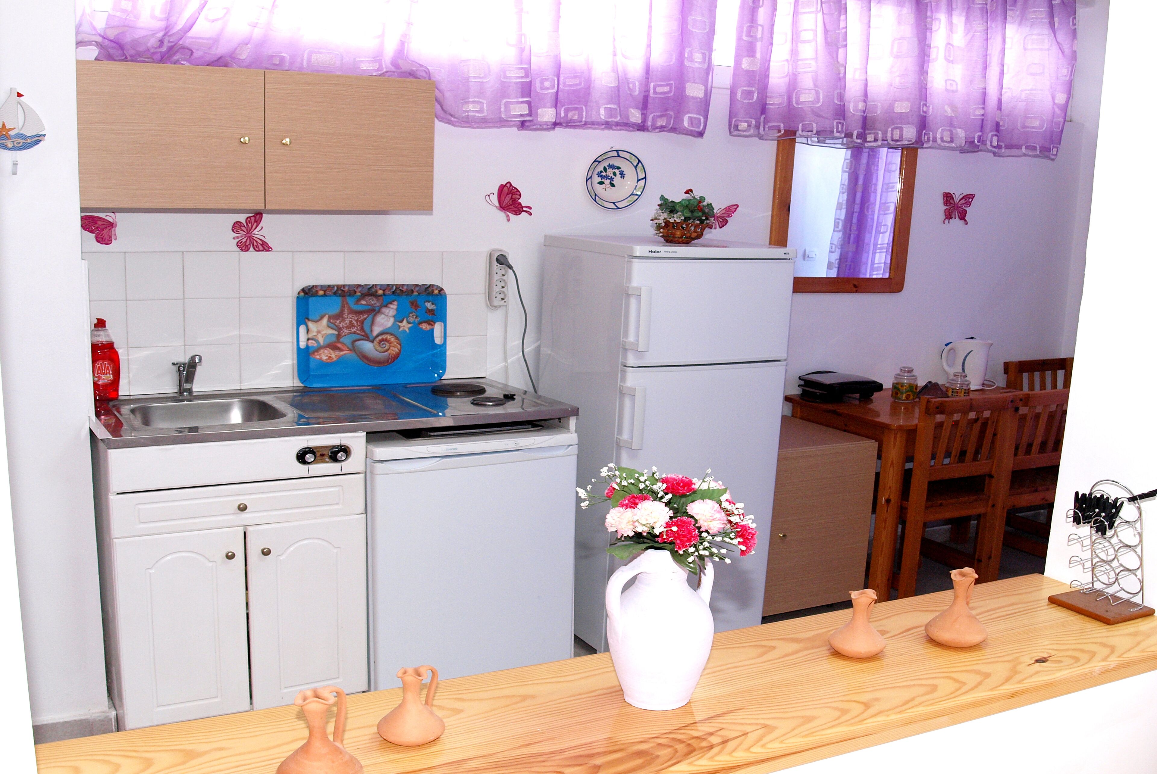 Mini-fridge, cookware/dishes/utensils, dining tables