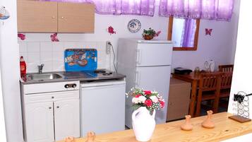Mini-fridge, cookware/dishes/utensils, dining tables