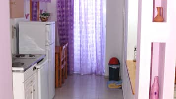 Mini-fridge, cookware/dishes/utensils, dining tables