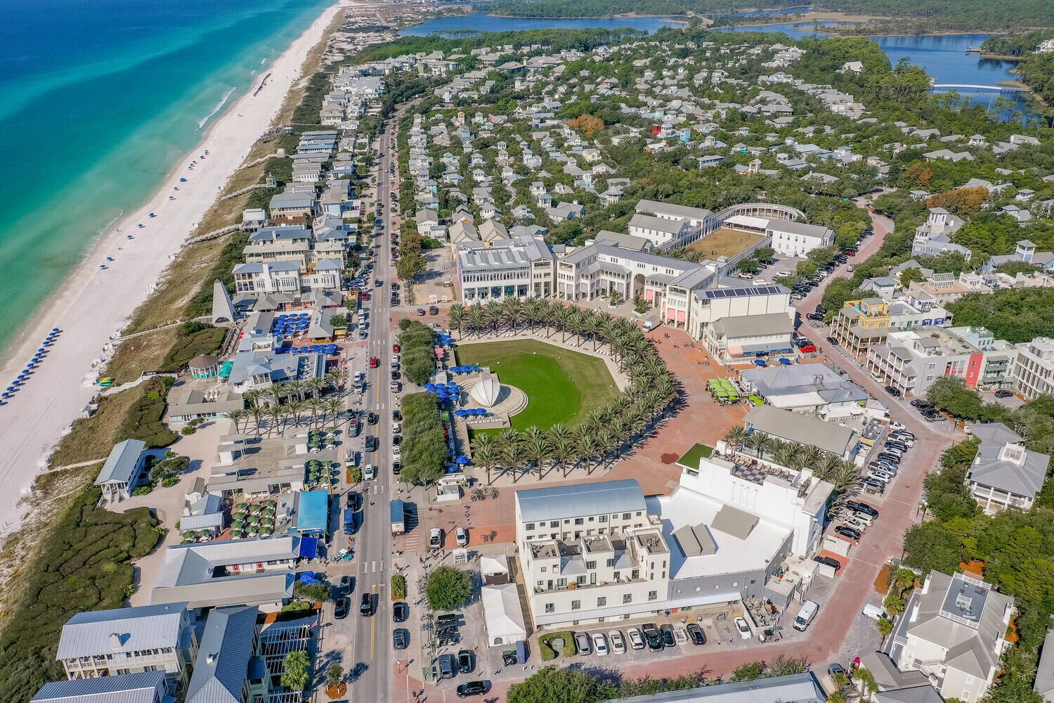 A coastal resort with beachfront properties, a central plaza, and a variety of buildings including a large hotel with a circular driveway.