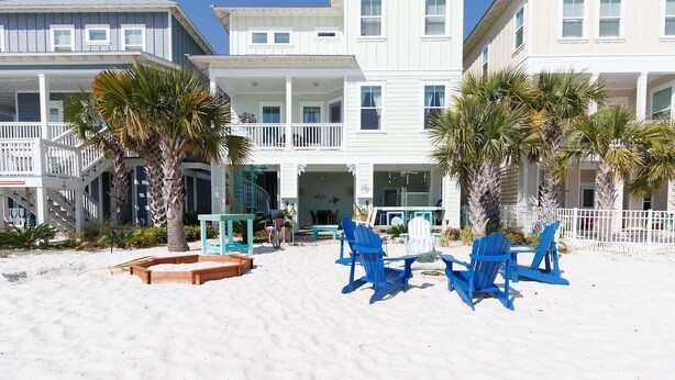 A beachfront hotel with multiple-story buildings, a covered patio, and outdoor seating. - Starfish Waterfront Family Retreat, Steps to Sound (Navarre)