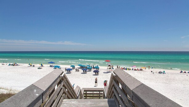 A beach with a wooden boardwalk leading to the shore, featuring umbrellas and beach chairs. - Dune Betty - 30A, Heated Private Pool, Walk to the Beach + Restaurants! (Santa Rosa Beach)
