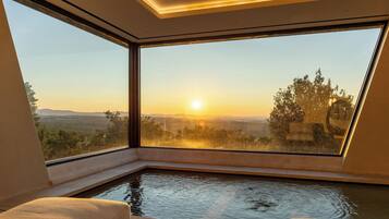Enjoy a serene atmosphere with a breathtaking view of distant hills from the large window.