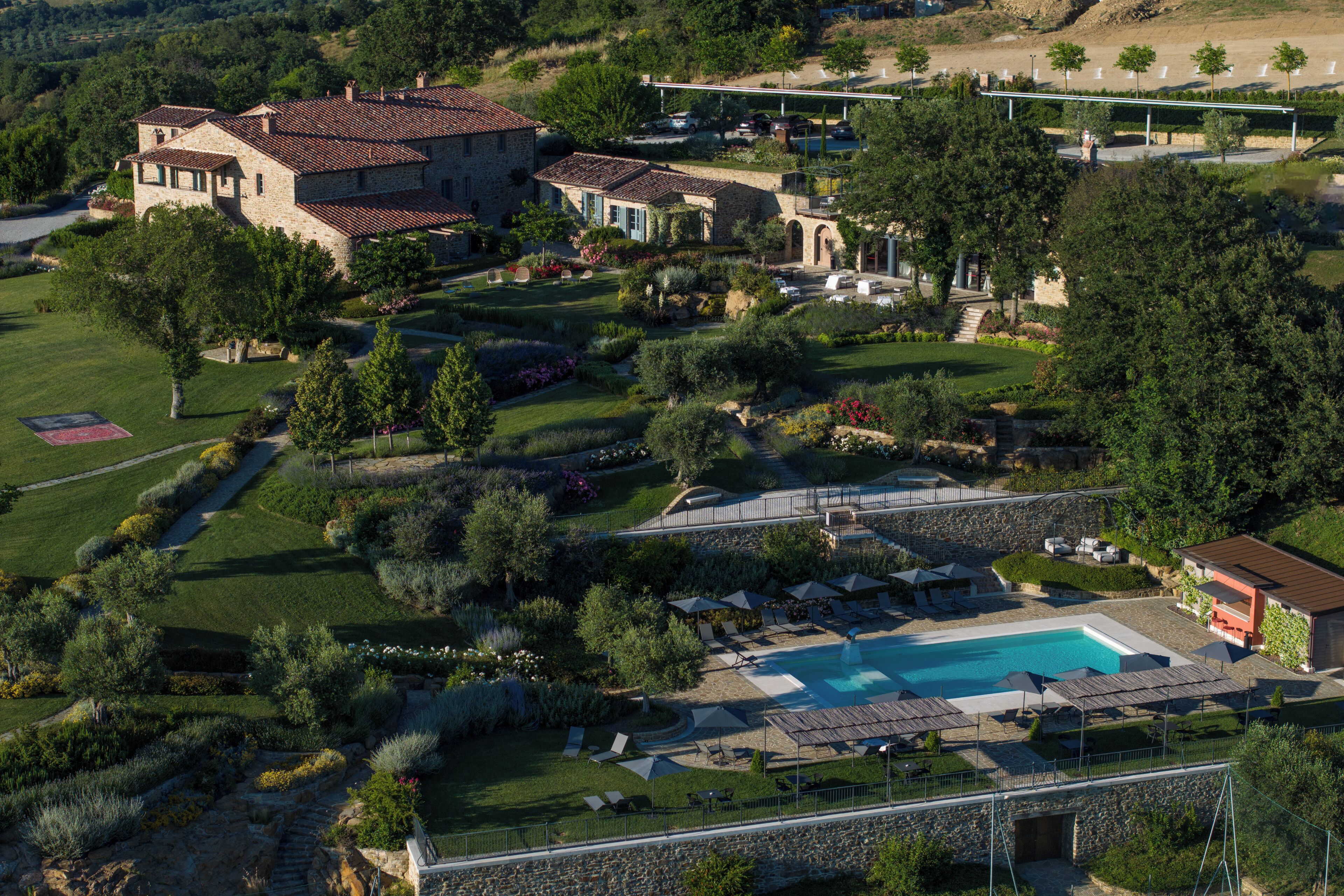A large estate with a swimming pool, multiple buildings, and extensive landscaping.