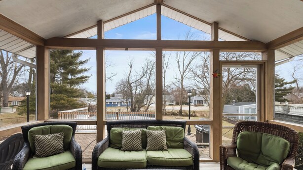 A covered patio with wicker furniture and a glass table. - Pool, Outdoor living, 100 yards from Lake Michigan! (New Buffalo)