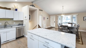 A modern kitchen with white cabinets, a granite countertop, and stainless steel appliances. - Pool, Outdoor living, 100 yards from Lake Michigan! (New Buffalo)