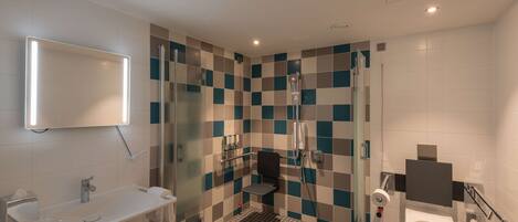 Un baño moderno con ducha, inodoro y lavamanos.