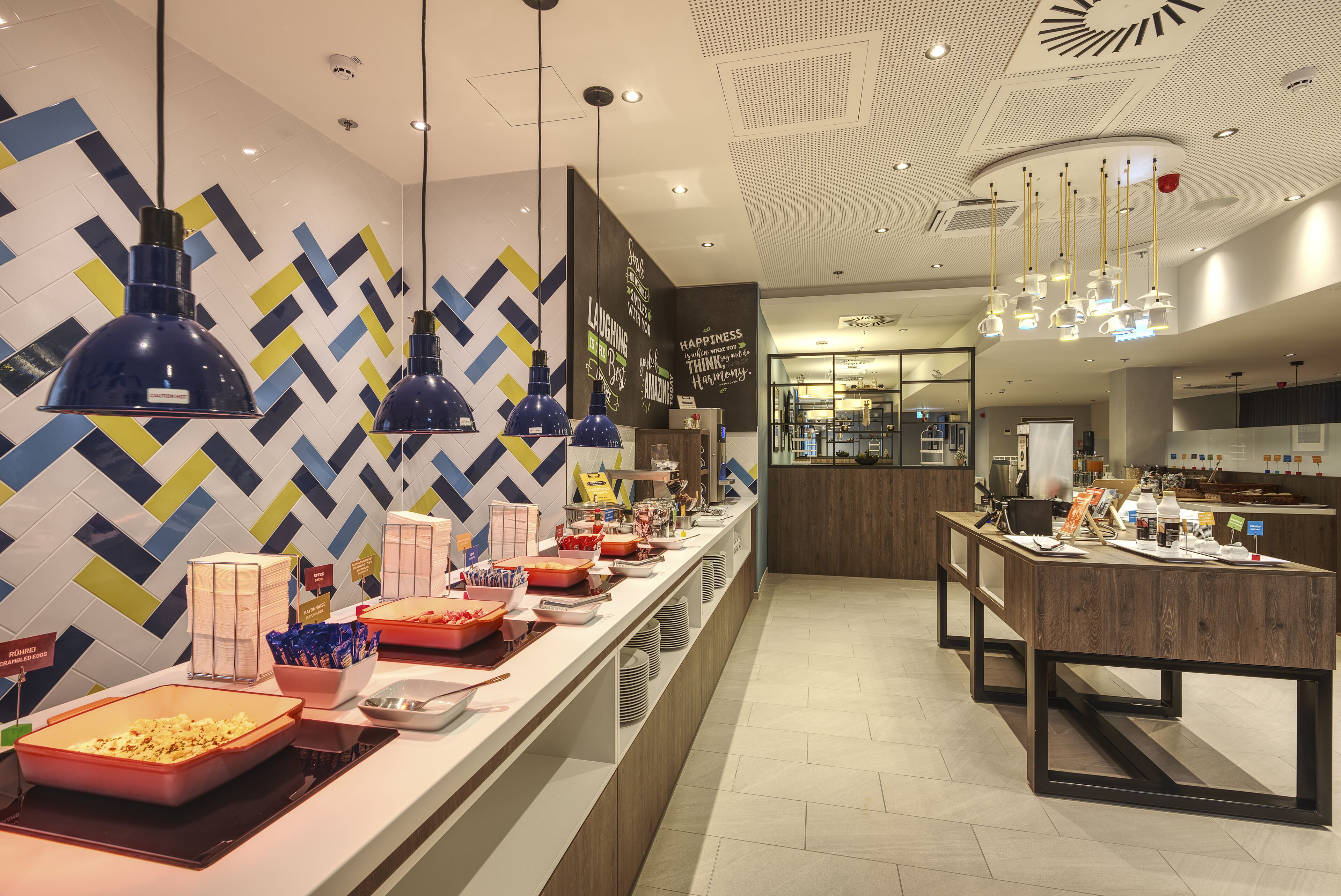 A buffet area with various food items and a modern interior design.