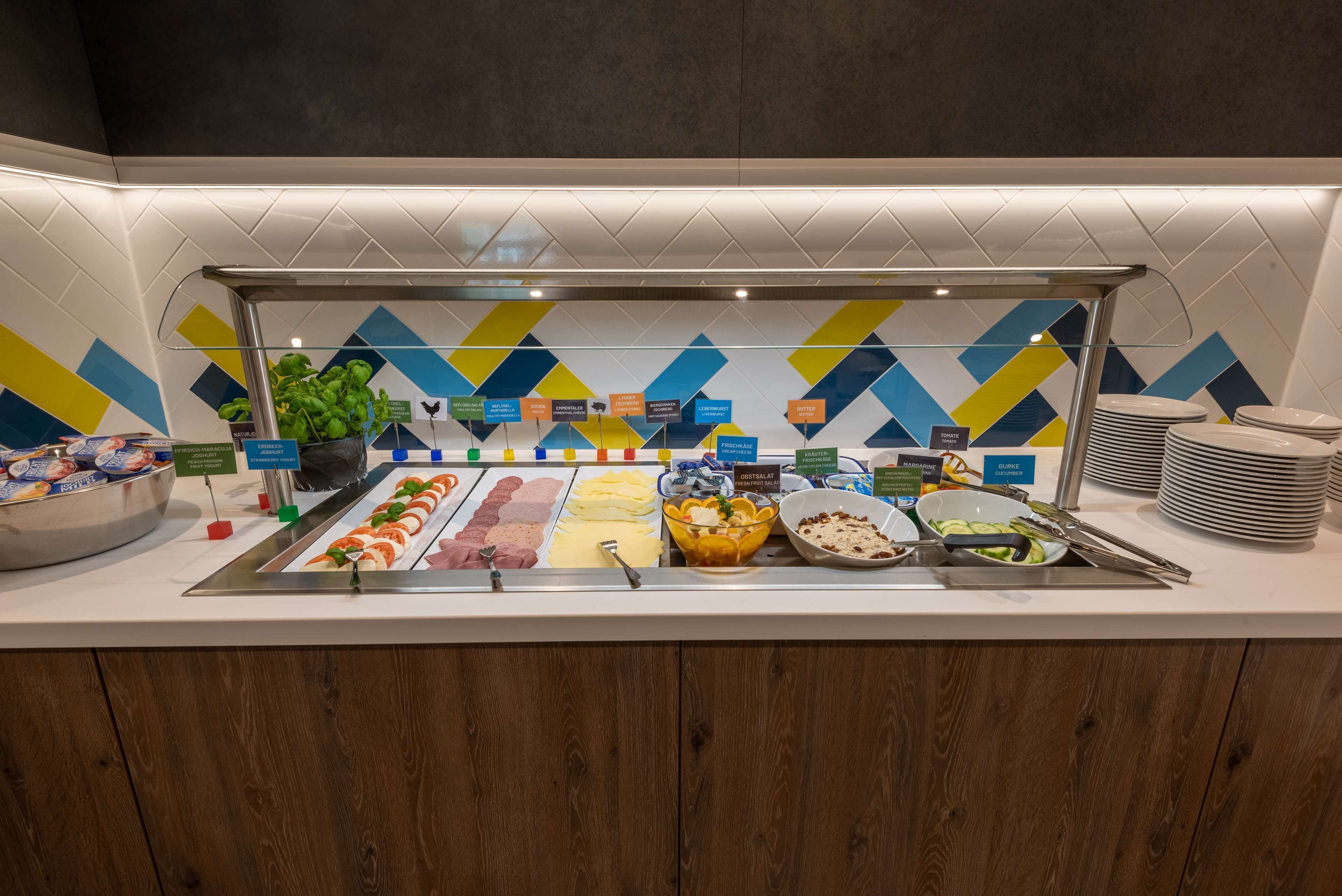 A buffet with various food items and labels.