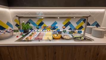 A buffet with various food items and labels.