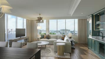 A modern living room with a sofa set, a coffee table, a TV, and a view of the city.