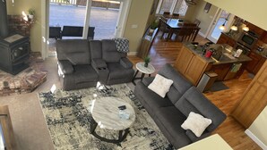 A modern living room with a sectional sofa, a round coffee table, and a fireplace.