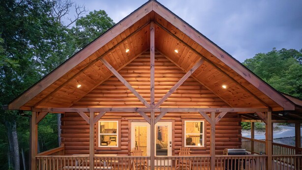 A log cabin with a balcony and a porch, surrounded by trees. - Incredible Views, Hot Tub, Pool Table, Waterfalls, Hiking (Bryson City)