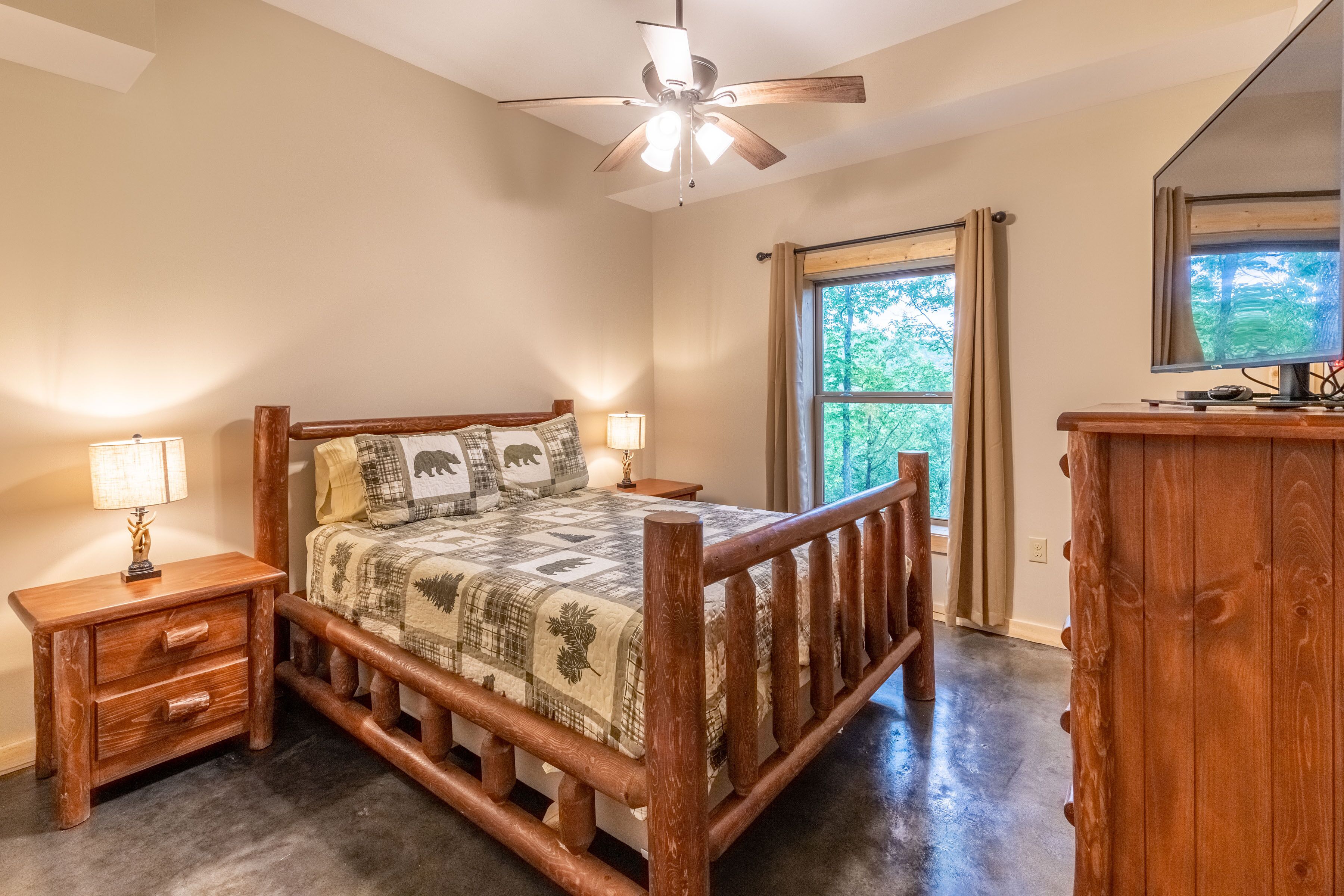 Lower level bedroom with queen bed, 2 nightstands, dresser, closet, and TV