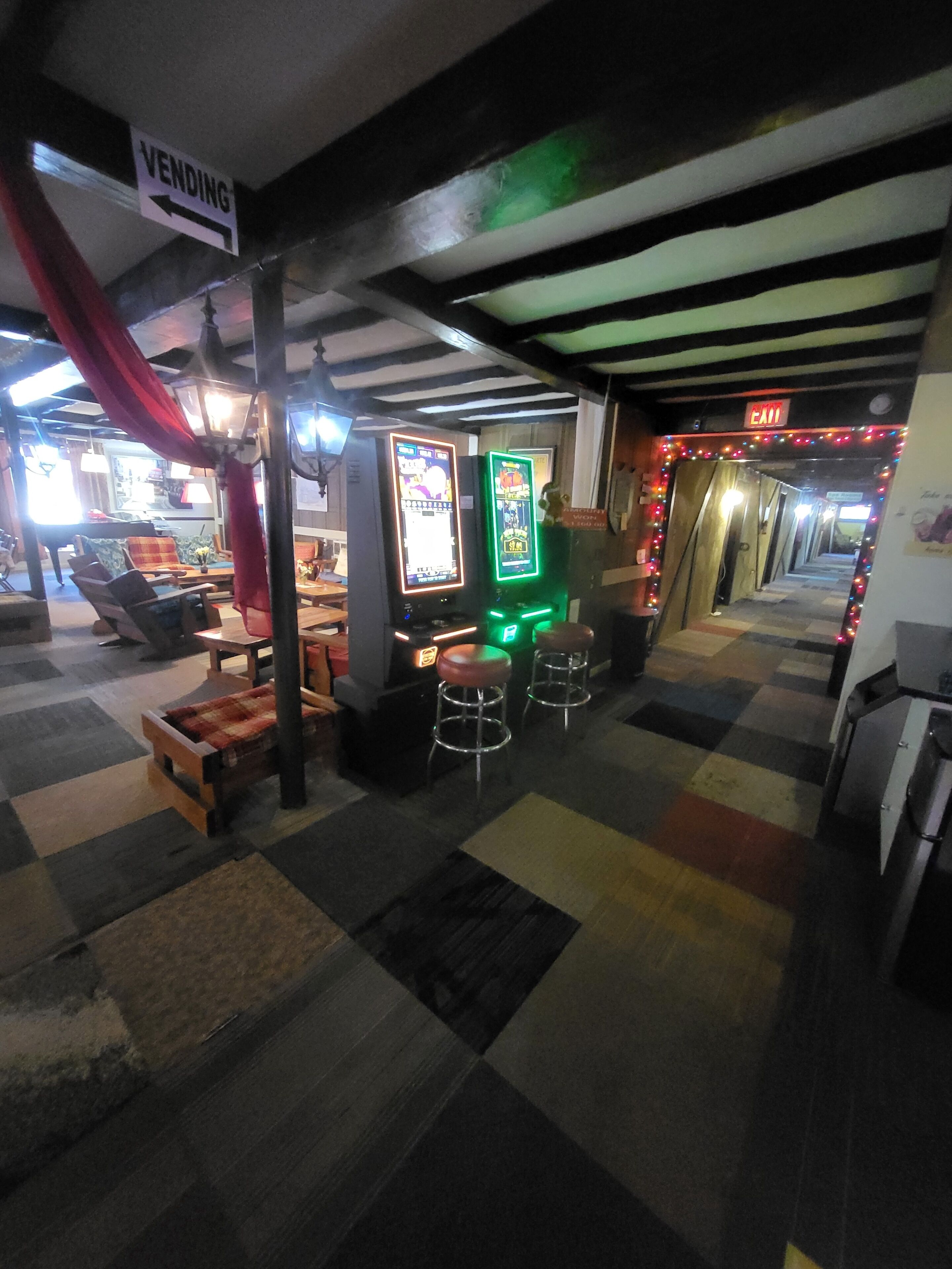 A bar area with stools, a vending machine, and a 'VENDING' sign.