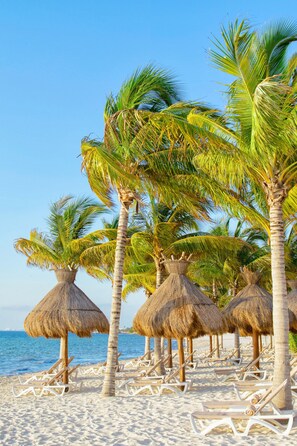 On the beach, white sand, free beach cabanas, sun loungers