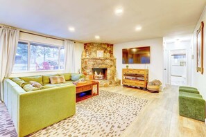 TV connectée, cheminée, table de tennis de table, livres