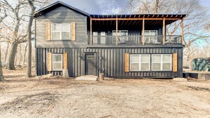 A two-story house with a balcony, a front door, and a garage.