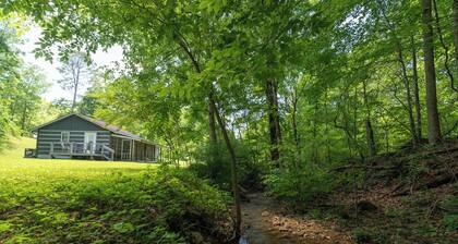 Moonshine Cabin with a nice yard on the creek in the shadows of the Smokies