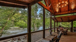 A wooden deck with outdoor seating overlooking a river. - Riverscape | Ellijay, GA (Ellijay)