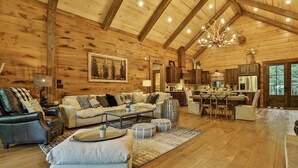 A log cabin interior with a living room, dining area, and kitchen. - Riverscape | Ellijay, GA (Ellijay)