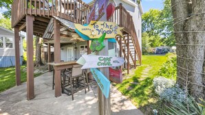 A wooden deck with a signpost indicating directions to various locations.