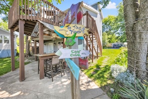 A wooden deck with a signpost indicating directions to various locations.