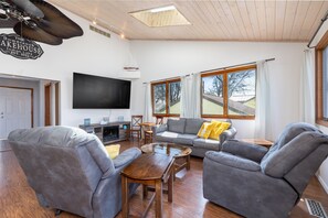 Smart-tv, een open haard, boeken en een kantoor