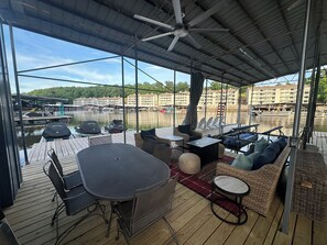 A covered outdoor area with a table, chairs, and lounge seating. - Quiet retreat, Deep Calm water. NOTE: NIGHTLY RATE INCLUDES FEES (Eldon)