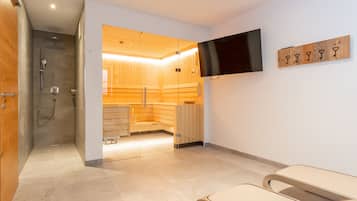 Relax in a serene space with a sauna, flat-screen TV, and comfortable seating area.