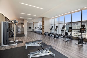A modern gym with cardio machines, weight stations, and benches. - Courtyard by Marriott Luoyang (Luoyang)
