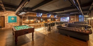 A billiards table, a bar area, and a seating area with sofas. - Novel Centre Point Hotel (Famagusta)