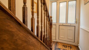 A wooden staircase leading to a white door with frosted glass panels. - 4-bed Detached, Pet Friendly House in Nelson (Nelson)