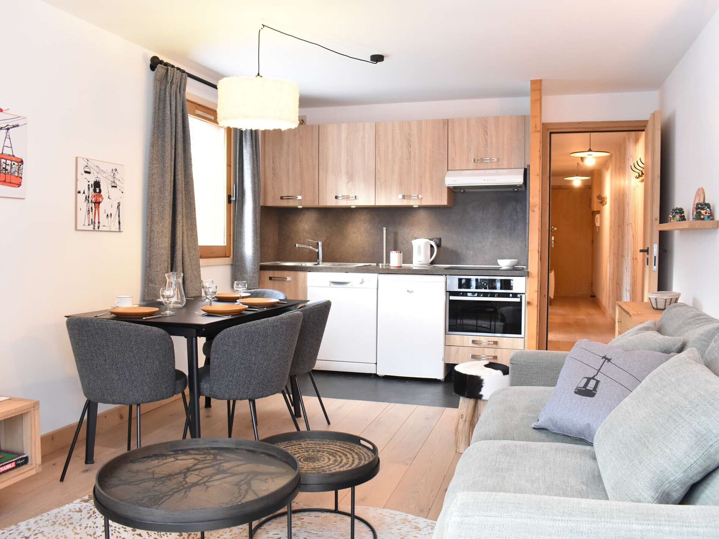 A modern apartment with a dining area, kitchen, and living room.