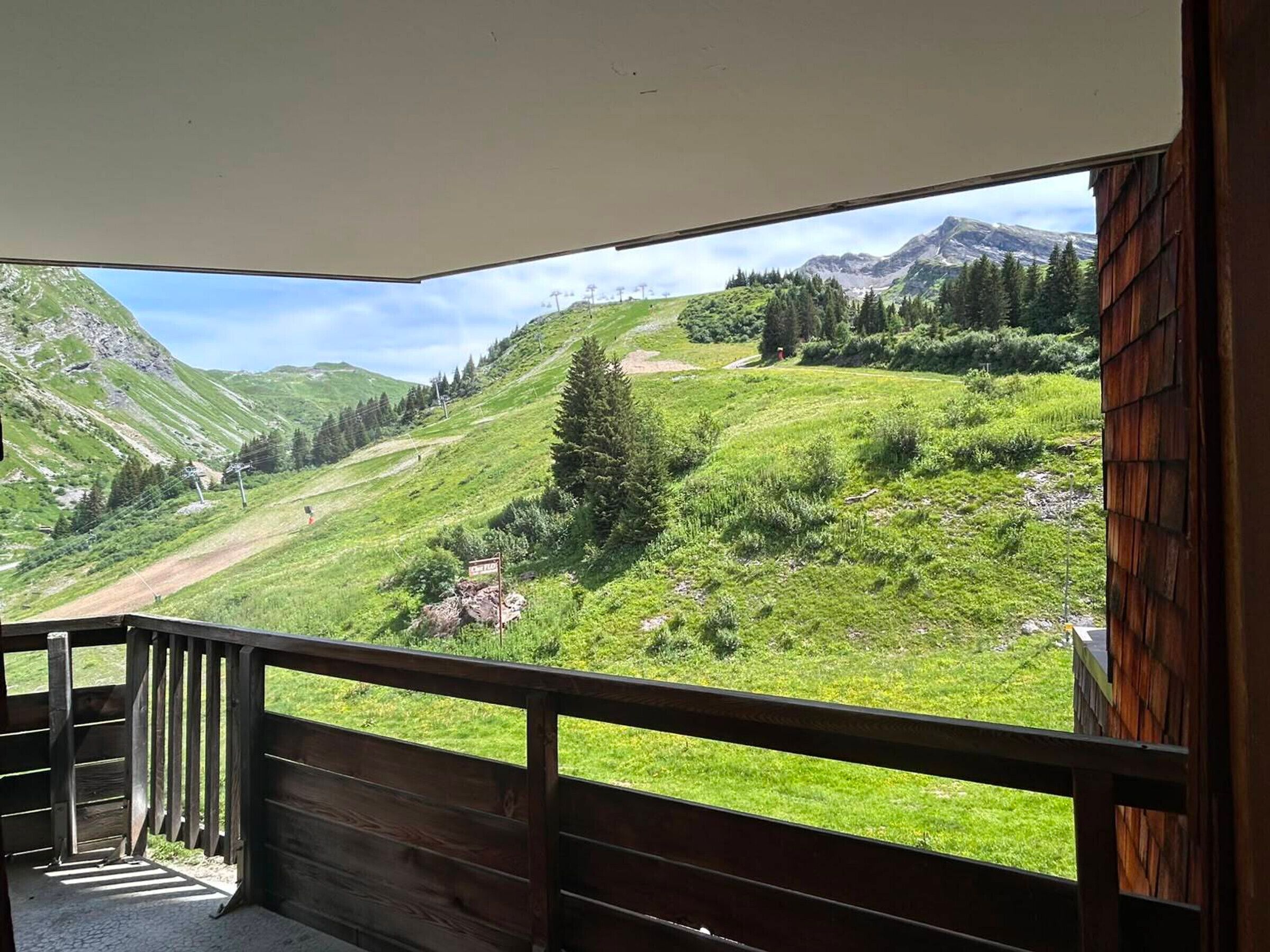 A balcony with a view of a mountainous landscape.