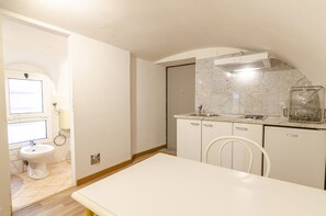 Fridge, electric kettle, cookware/dishes/utensils, dining tables