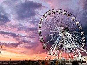 A large Ferris wheel with cabins labeled "MIX" against a sunset sky. - Watercolours on Marina (Glenelg)