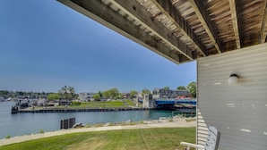 Une terrasse couverte offrant une vue sur un port de plaisance et un pont.