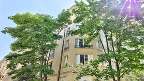 A multi-story building with balconies and windows, surrounded by trees. - YOUR SOLUTION TO A LUXURY STAY- 250M2 TOP LUXURY CHAMPS ELYSEES (Paris)