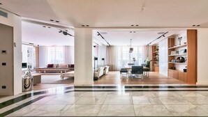 A spacious living area with a dining table, chairs, and a sofa. - YOUR SOLUTION TO A LUXURY STAY- 250M2 TOP LUXURY CHAMPS ELYSEES (Paris)