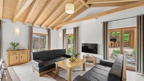 A spacious living area with a wooden ceiling, a sofa, a coffee table, and a television. - Villa Bonassini with whirlpool, sauna and 4 bedrooms  (Svetvinčenat)