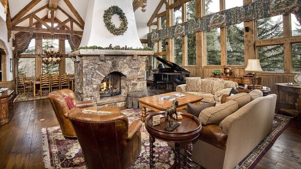 A spacious living room with a stone fireplace, a grand piano, and a cozy seating area. - 349 Holden Rd. 5 Bedroom Home by RedAwning (Avon)