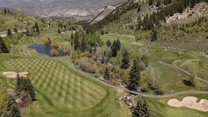 A golf course with a pond, surrounded by trees and hills. - 349 Holden Rd. 5 Bedroom Home by RedAwning (Avon)