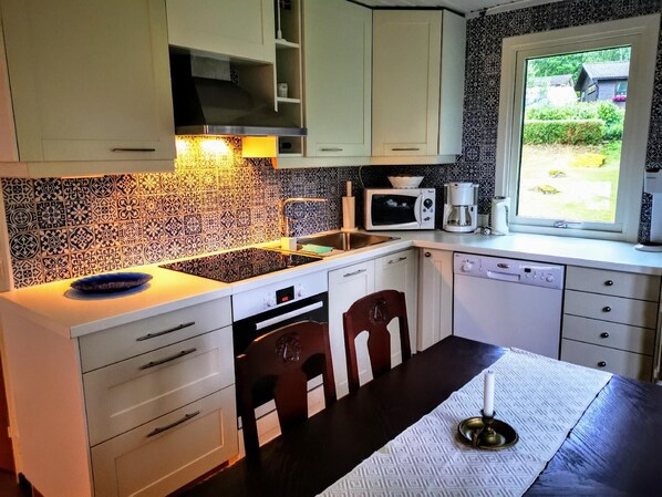 Enjoy cooking in this kitchen with a microwave, coffee maker, and dishwasher, and take in the view from the window.