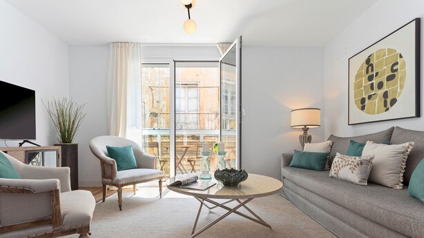 A modern living room with a sofa, armchairs, a coffee table, and a TV. - Genteel Home San Antonio IV (Cadiz)