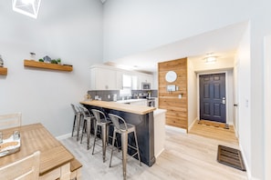 Enjoy casual dining and relaxation in this kitchen with a central island, cabinetry, and a seating area.