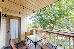 Enjoy dining or socializing in this covered outdoor space with a glass table and four chairs.