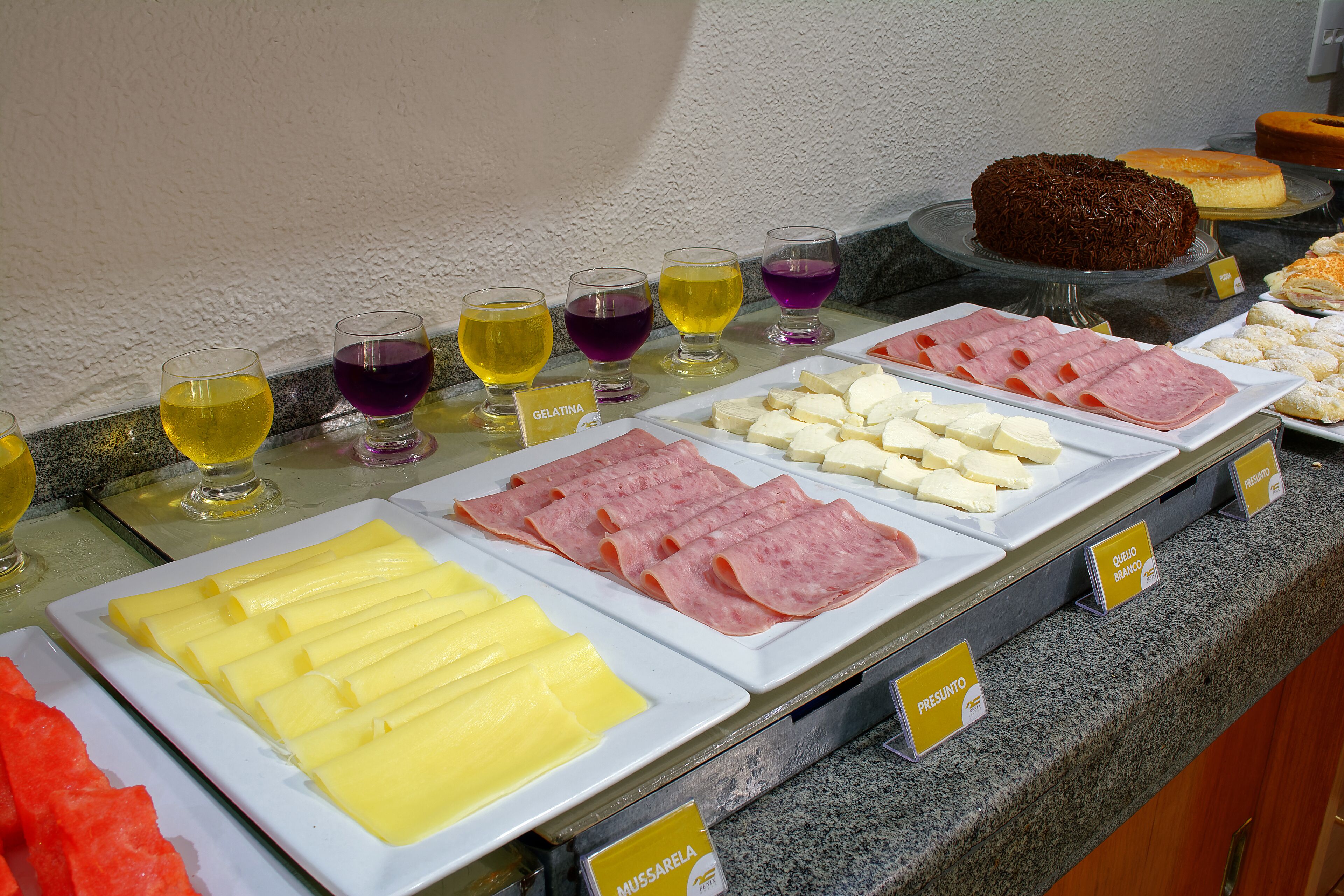 A buffet with various food items and beverages.