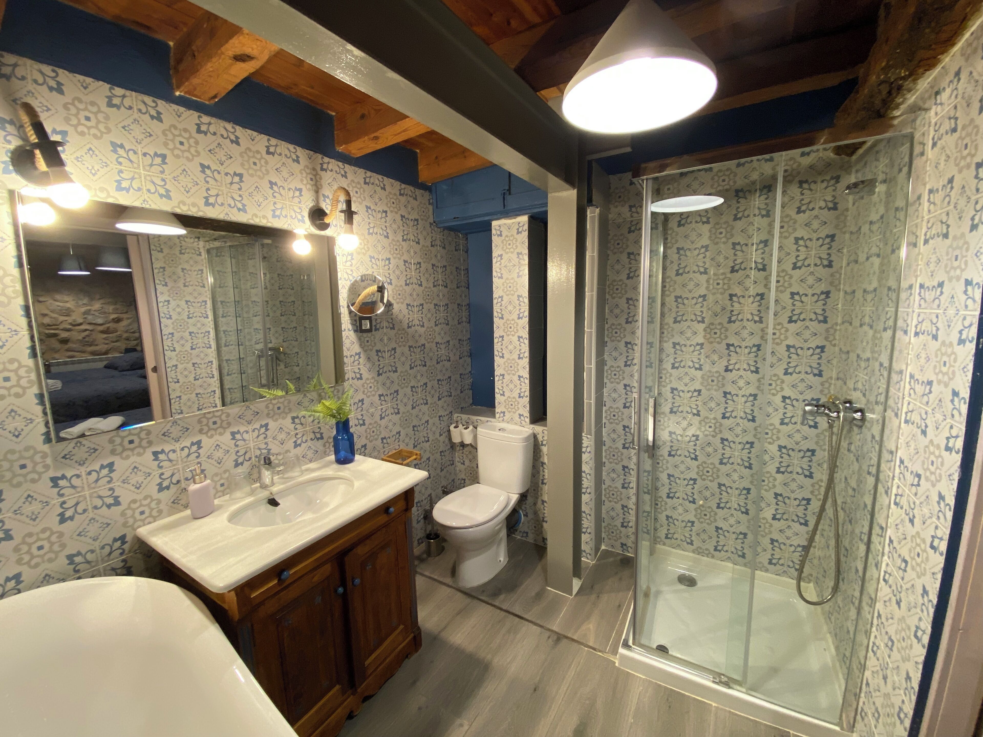 A bathroom with a shower, toilet, and sink.